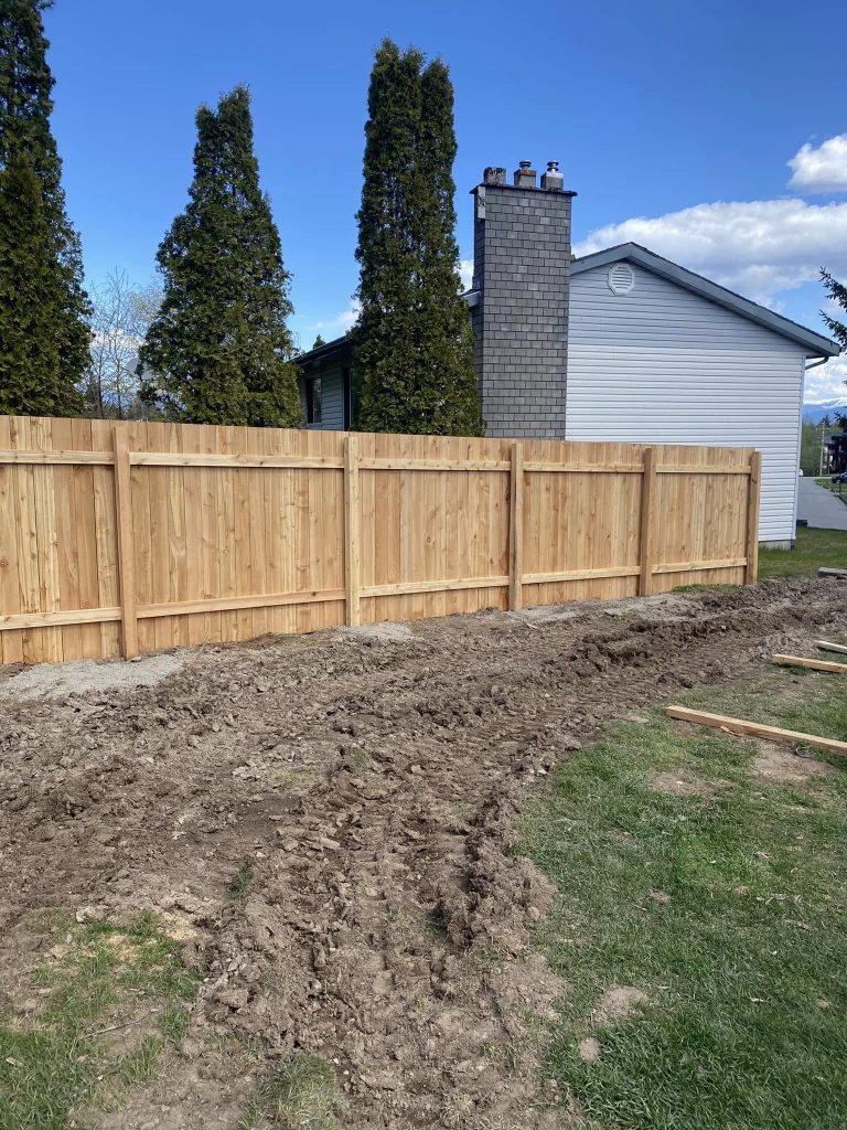 Wood privacy fence installation beside residential yard