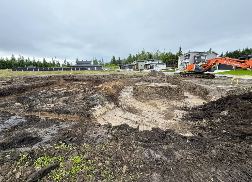 Large disturbed work area with active earthmoving and site preparation underway.