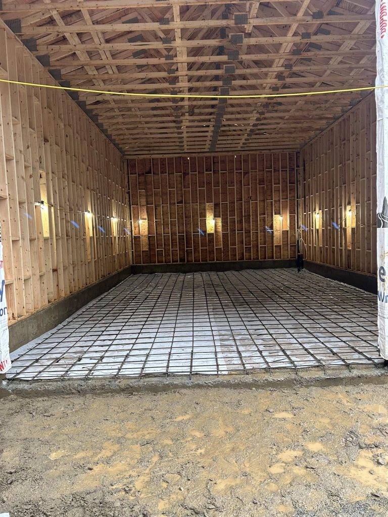 Interior concrete slab preparation with rebar grid before pour